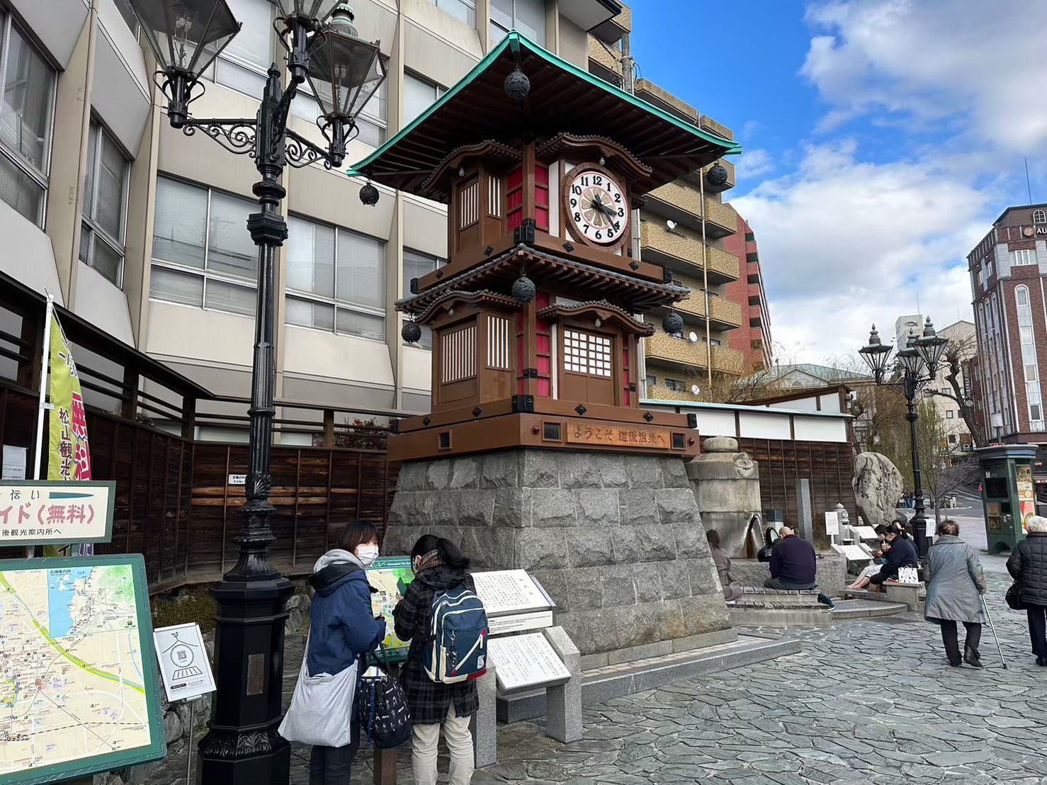 Botchan Karakuri Clock at Dogo Onsen Station square with foot bath (ashiyu) at the base
